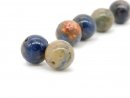 Two pierced, coloured sodalite balls