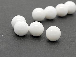 Four white pierced mother-of-pearl beads