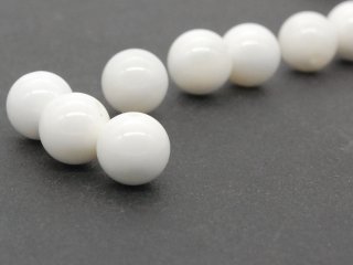 Three white, pierced mother-of-pearl balls