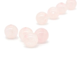 Four pierced rose quartz balls