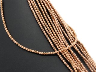 Pierced, rose gold haematite spheres