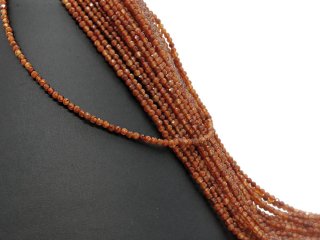 Orange-coloured, pierced, faceted garnet beads