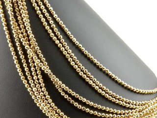 Pierced, sparkling, golden haematite spheres