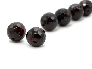 Two faceted pierced garnet beads