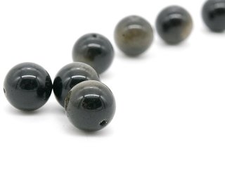 Three pierced, shimmering obsidian balls