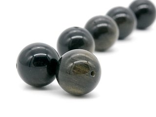 Two pierced, shimmering obsidian balls