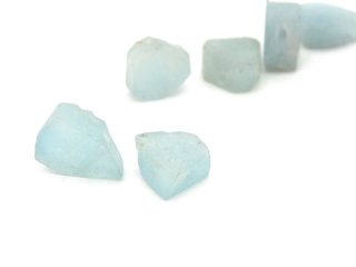 Two pierced aquamarine gemstones