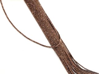 Sparkling brown hematite strand hangs over a bust with more hematite strands behind it