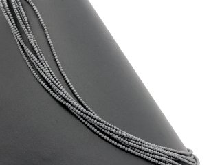 Frosted, pierced spheres made of hematite in grey
