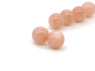Two peach coloured moonstone beads