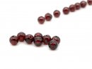 Eight pierced garnet balls