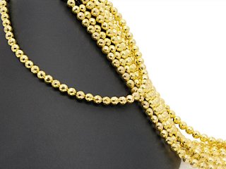 Pierced, sparkling, golden haematite spheres
