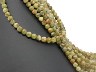 Pierced, green-red gemstone beads made of serpentine