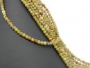 Pierced, green-red gemstone beads made of serpentine