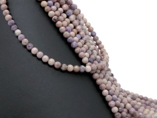 Pierced, purple-coloured lepidolite spheres