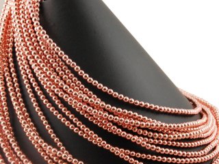 Pierced, rose gold haematite spheres