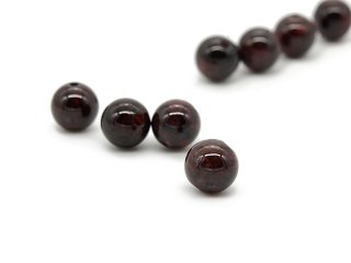 Four pierced red garnet balls