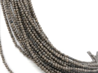 Shimmering, brown-grey, pierced, small feldspar spheres