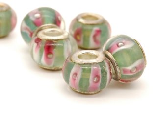 Two green glass beads with a metal centre and pink and white pattern