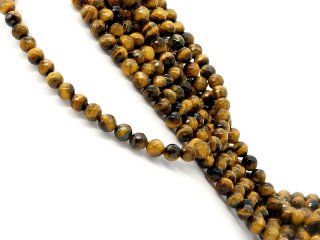 Faceted, pierced, golden-brown tigers eye spheres