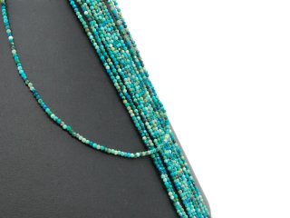 Small, faceted, pierced chrysocolla spheres