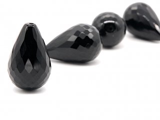A pierced, black onyx drop with facets