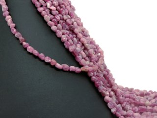 Pierced, magenta-coloured tourmaline beads