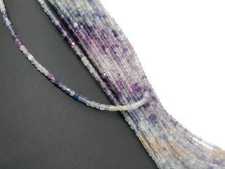 Pierced, colourful fluorite cubes with facets