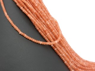 Orangefarbene, durchbohrte, facettierte Achatrondelle