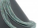 Faceted, pierced apatite rondelles in green-blue