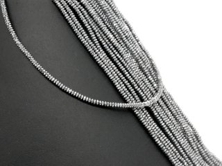 Faceted, small hematite lenses in grey
