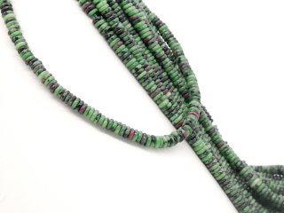 Colourful, pierced ruby rondels in zoisite