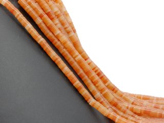 Orange-coloured, perforated calcite discs