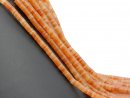 Orange-coloured, perforated calcite discs