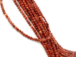Pierced, faceted fire agate discs in orange-red