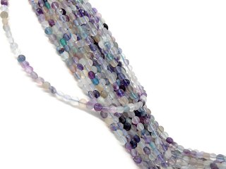 Pierced, colourful fluorite discs with facets