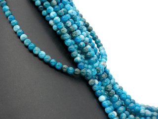 Pierced, blue spheres made of apatite