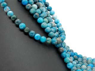 Pierced, blue spheres made of apatite