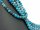 Pierced, blue spheres made of apatite