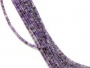 Pierced, purple-coloured fluorite discs