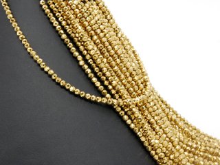 Pierced, sparkling, golden haematite spheres