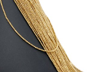 Pierced, sparkling, golden haematite spheres