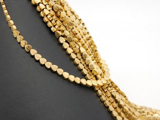 Pierced, sparkling, golden haematite leaves