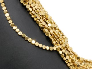 Pierced, sparkling, golden haematite discs