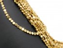 Pierced, sparkling, golden haematite discs