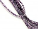 Pierced, purple-coloured fluorite discs