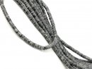 Pierced, shimmering grey jasper discs