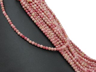 Durchbohrte, facettierte Rhodonite in Rosa und Sand