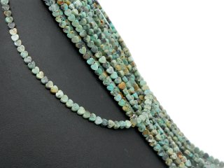 Turquoise-coloured, patterned, pierced turquoise discs in the shape of a heart
