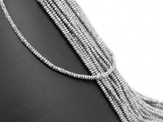 Pierced, silver-coloured, faceted hematite rondelles
